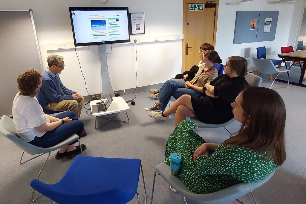 A group of editors looking at a screen during a training session